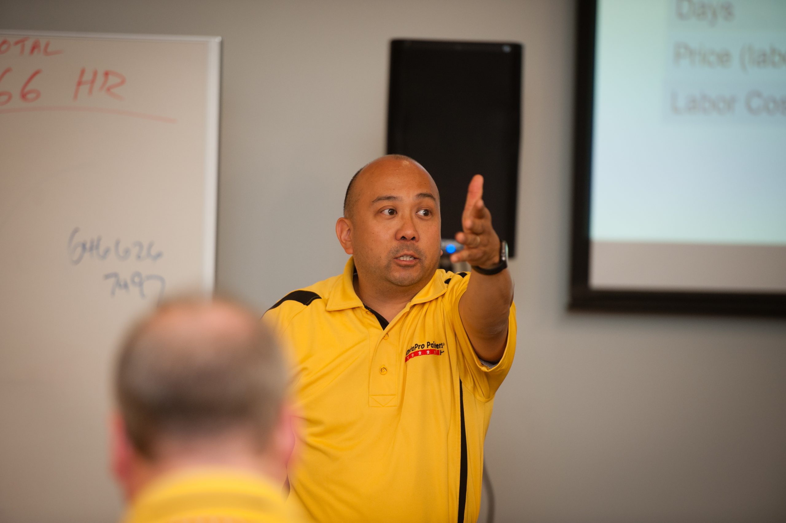 Training Specialist talking to a group of franchise owners in a room