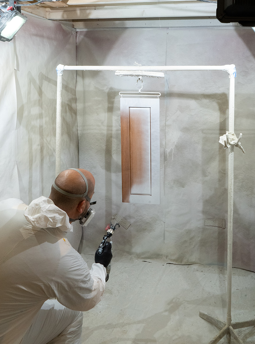 image of professional spraying kitchen cabinets