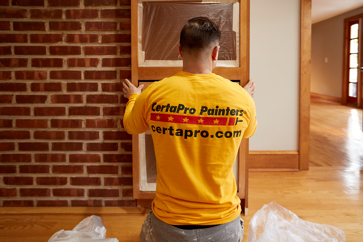 professional painter painting kitchen cabinets