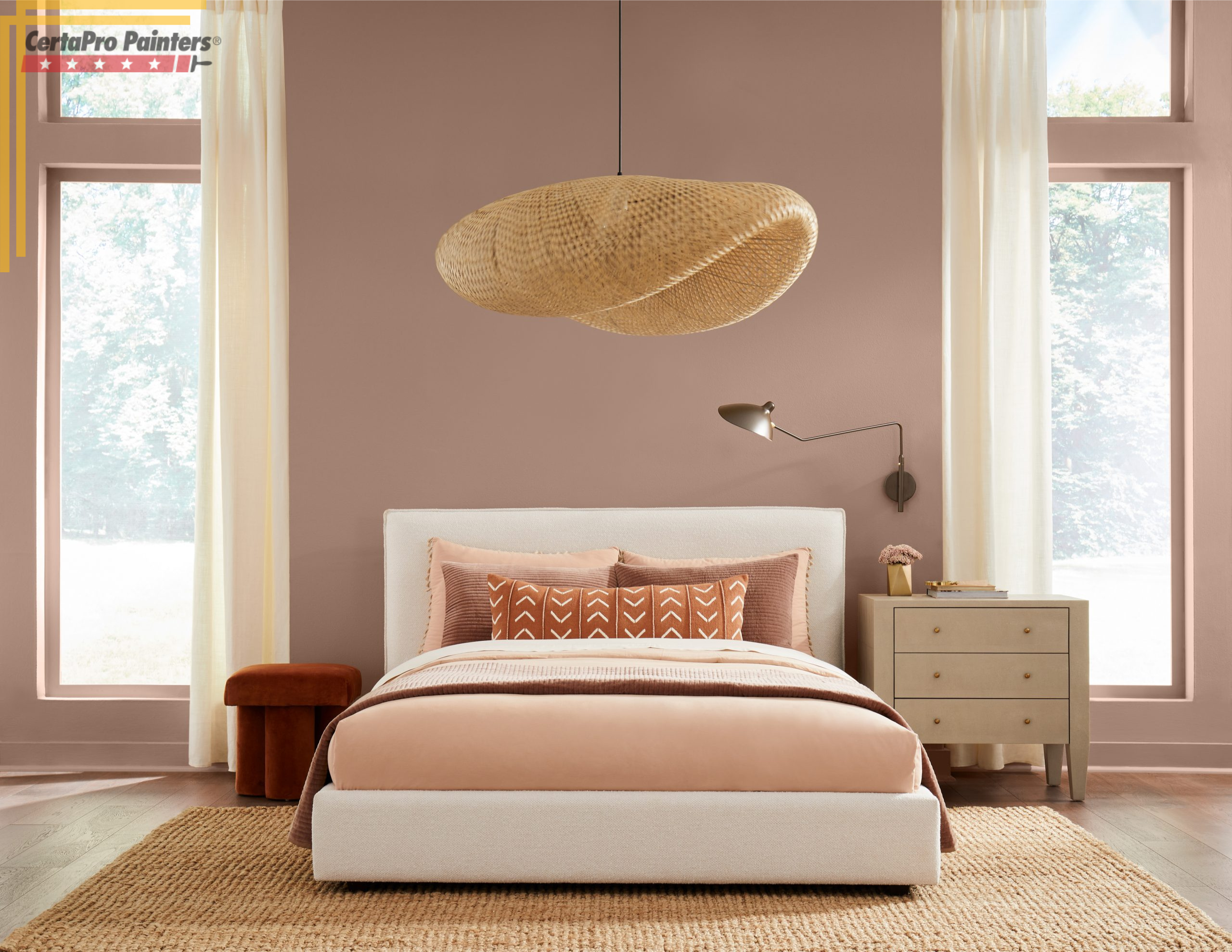 bed and wicker light fixture in pink painted room