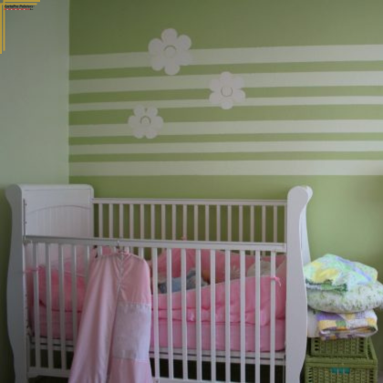 green painted nursery with white crib
