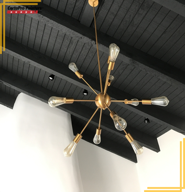 black painted exposed beam ceiling with light fixture