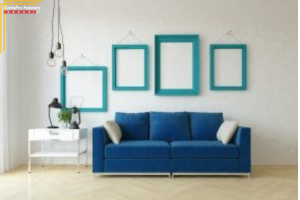 blue couch in front of white wall with teal frames