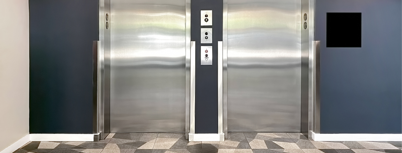 elevators inside an apartment building with blue walls