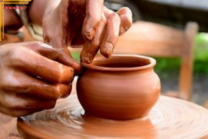 close up of hands working on a clay pot