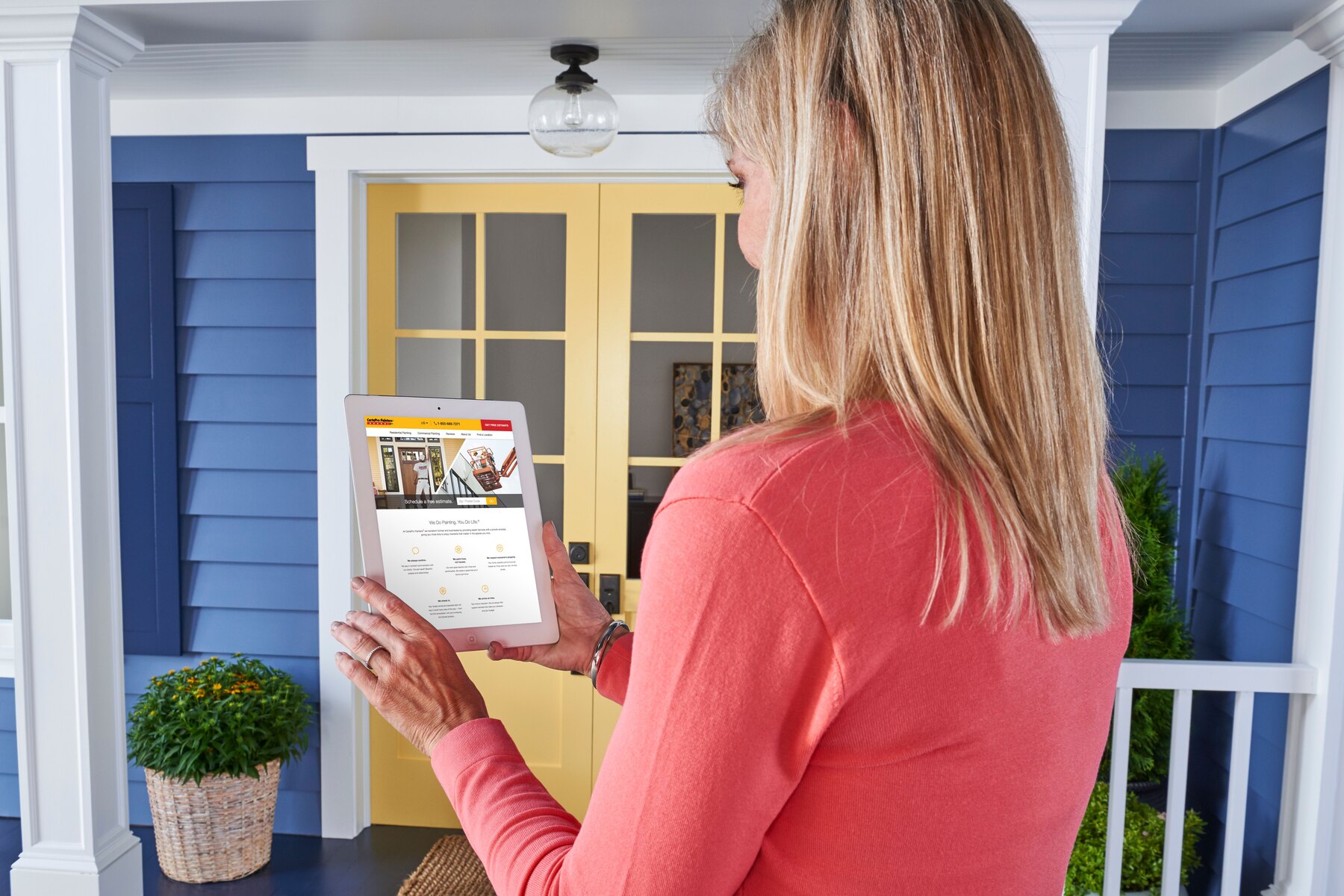 Homeowner reviewing painting project details on a tablet