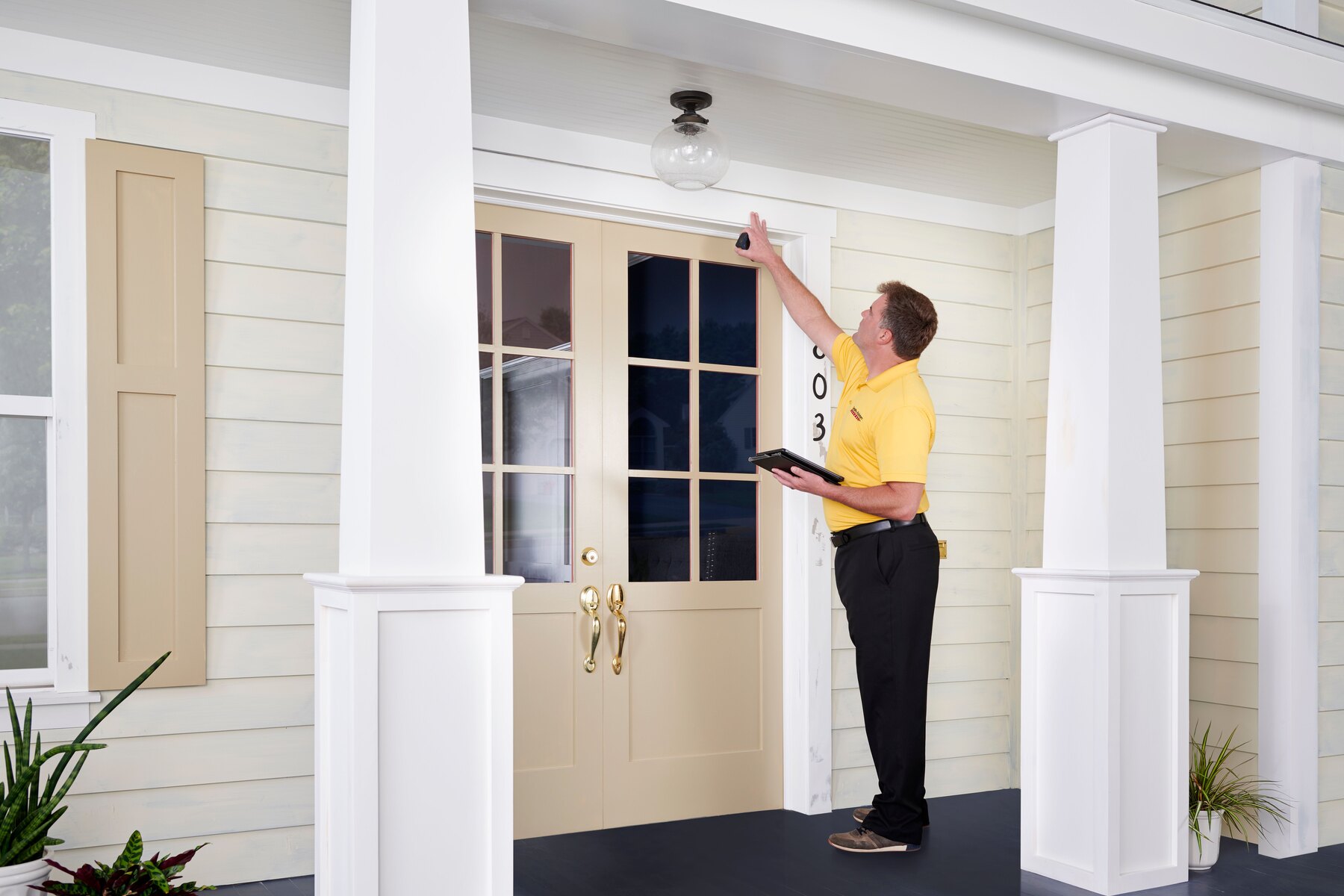 CertaPro representative inspecting a home exterior during an estimate