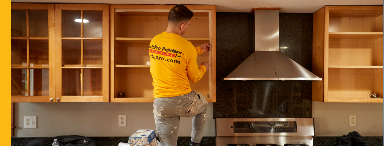certapro painters team member in progress of kitchen cabinet painting
