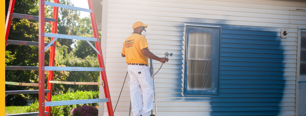 certapro painters team member painting a home exterior
