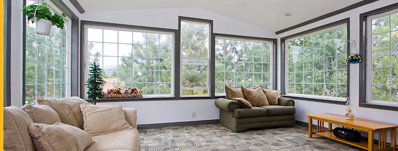 Sunroom in home with white walls and grey trim