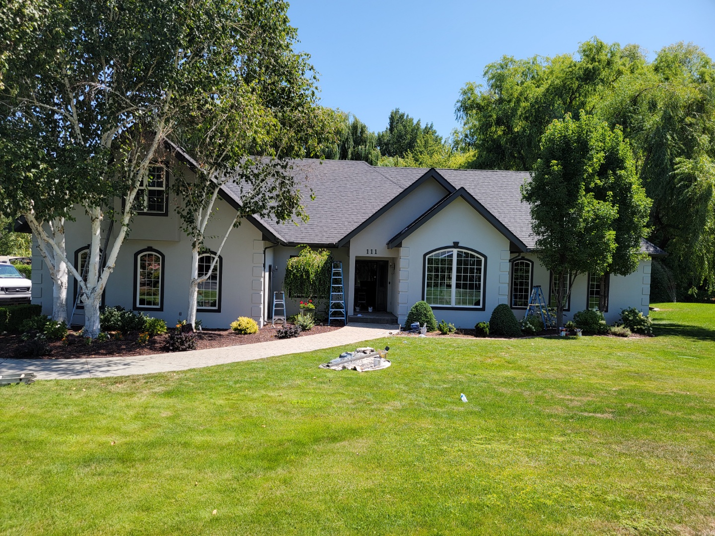White w/ Black Trim Painted Stucco House After