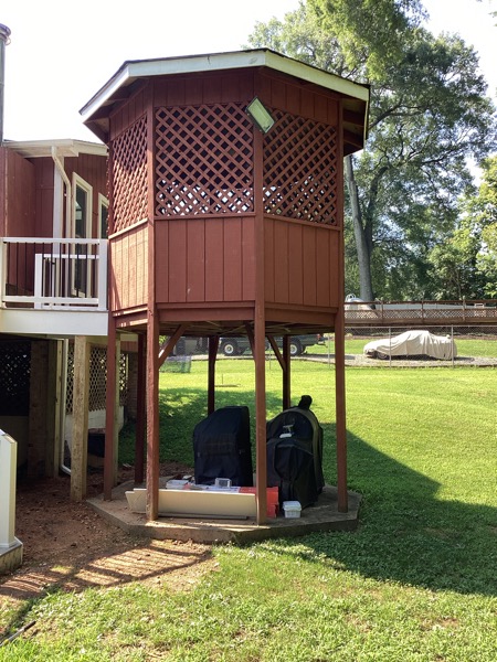 red stained back covered deck