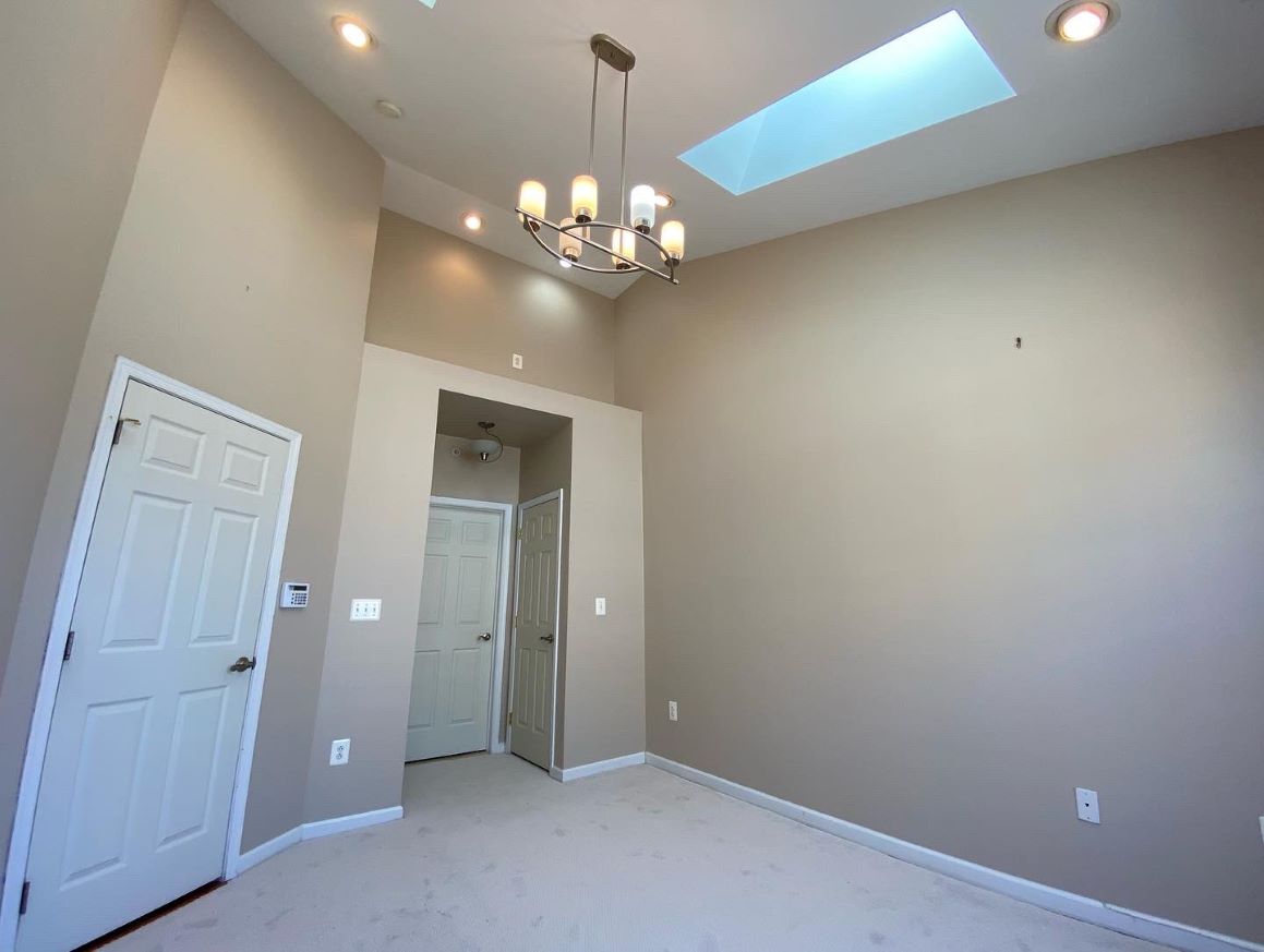 interior room with skylight after painting