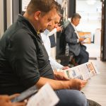 men reading pamphlets