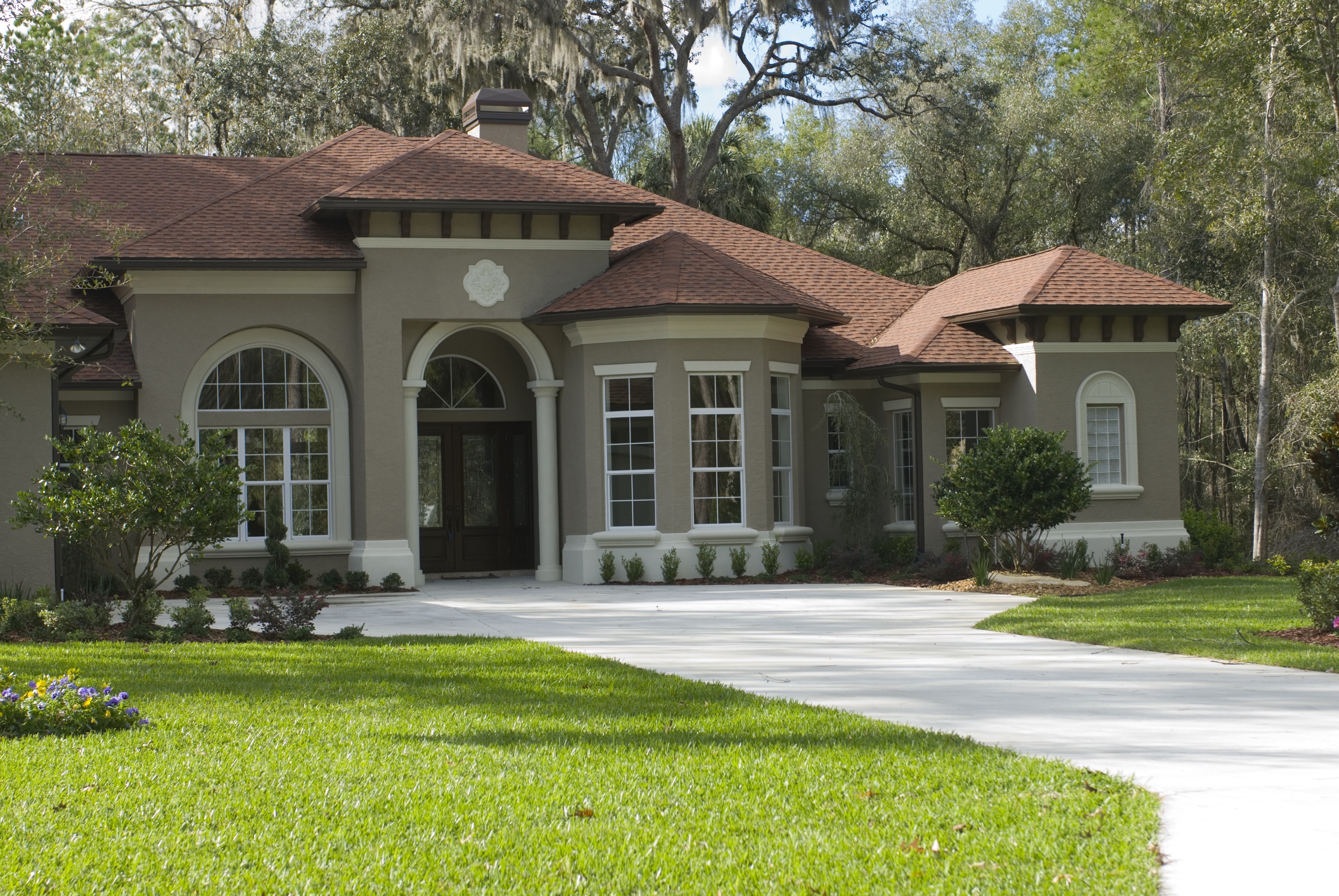 Newly constructed home with brown stucco
