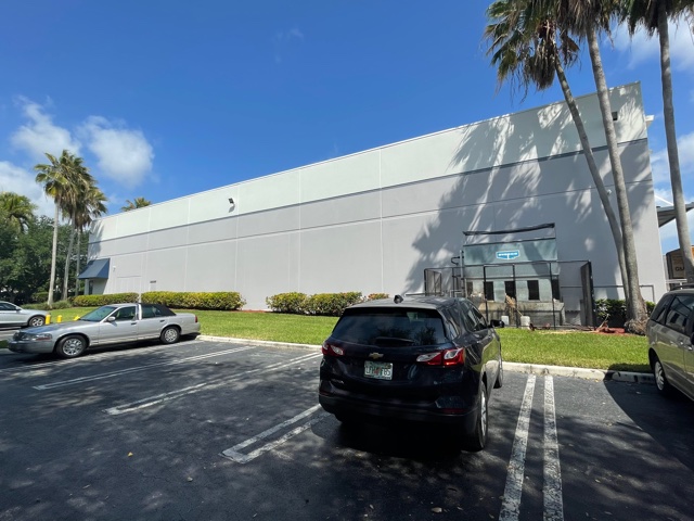 Commercial Light Carpentry Services man painting side of building