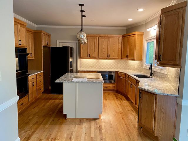 photo of kitchen cabinets and island before being repainted