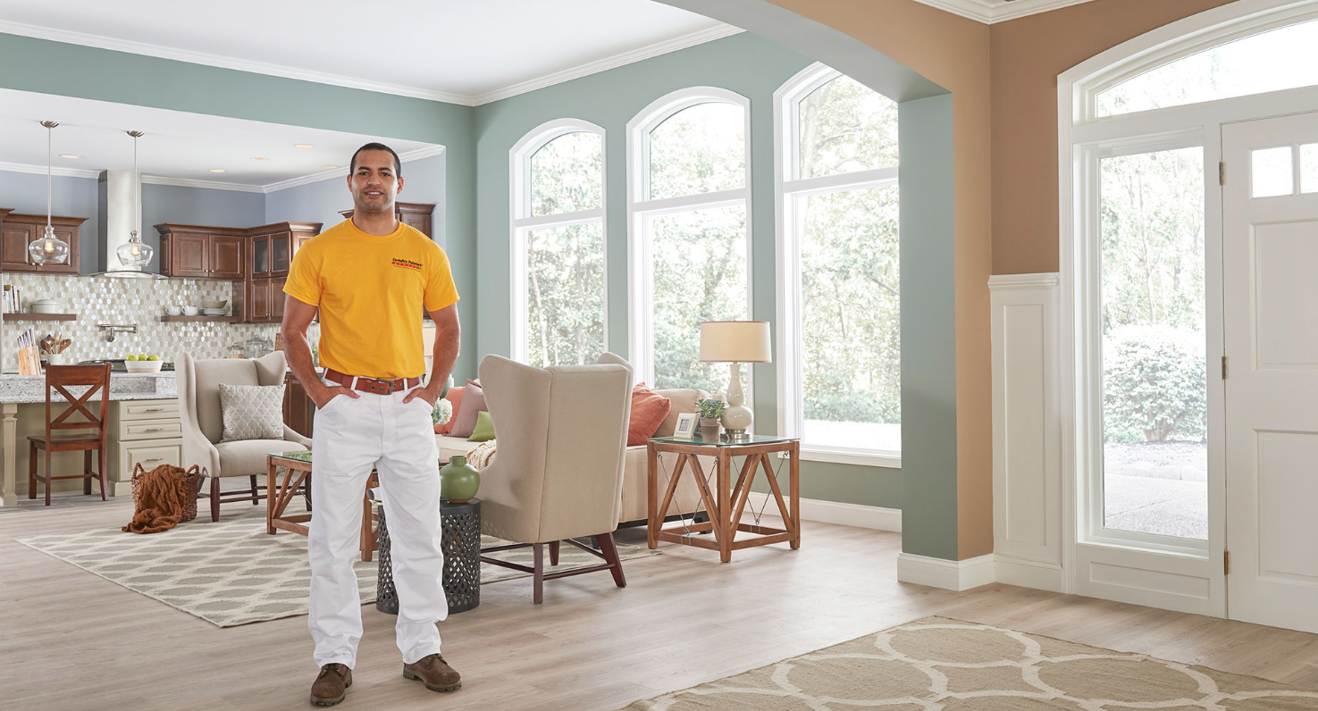 CertaPro Professional Painter standing in a freshly painted living room
