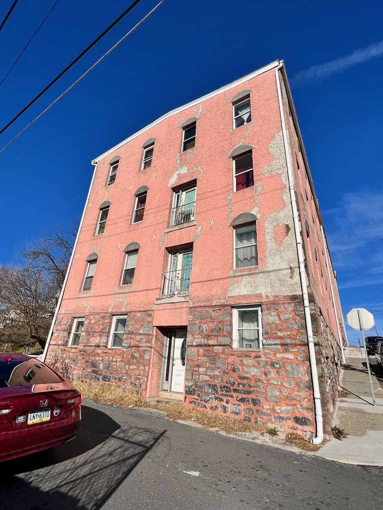 Side of River Rock Management before commercial exterior painting project for CertaPro Painters of the Greater Lehigh Valley - Angle 2