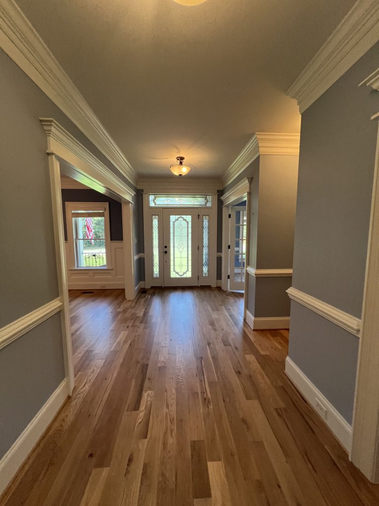home hallway with blue walls and white trim