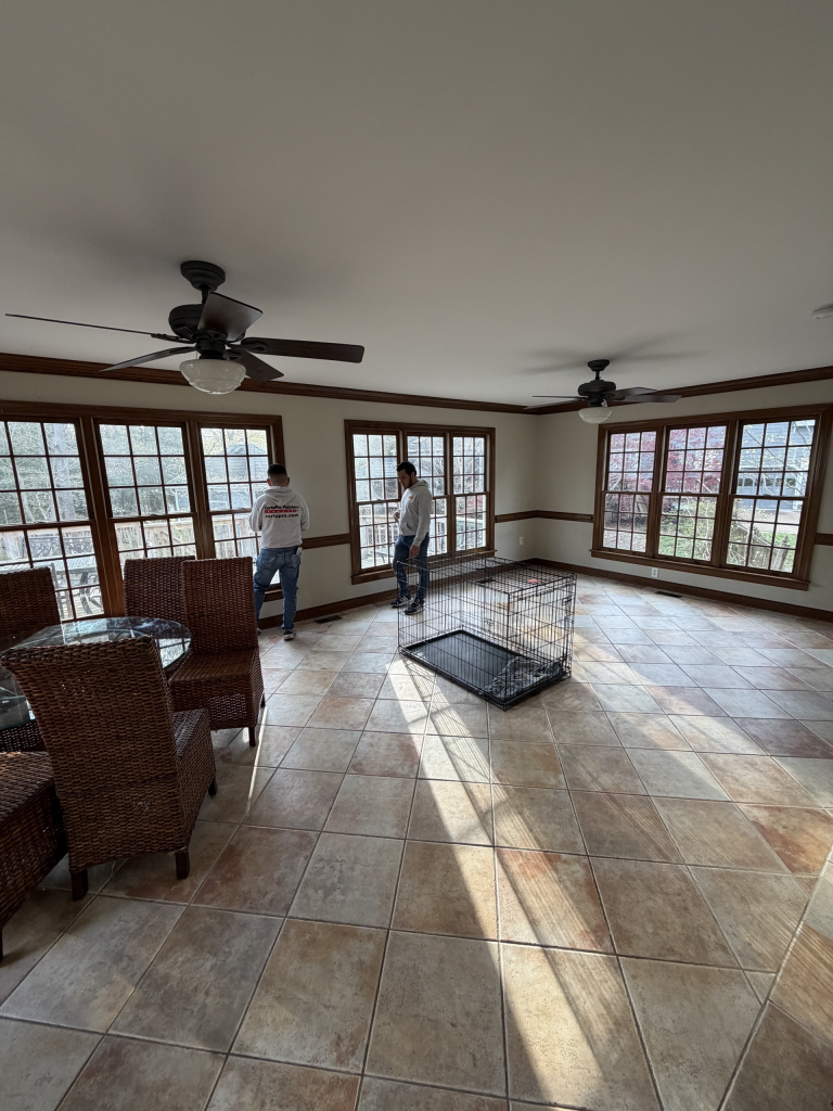 enclosed sunroom with white walls and stained wood trim and molding