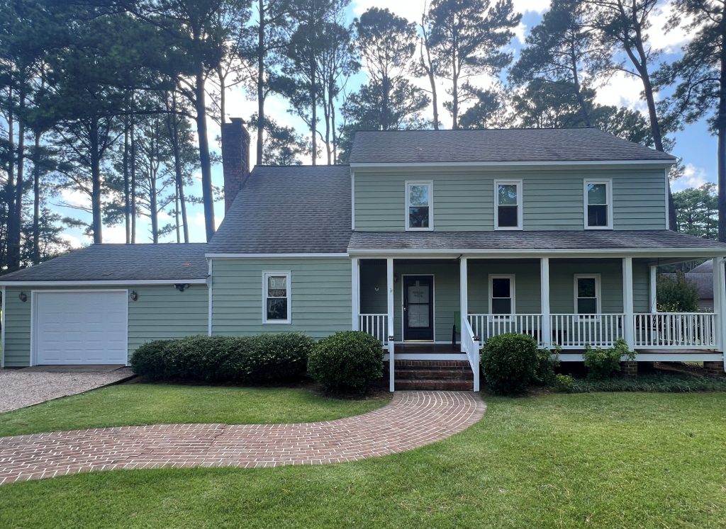 front exterior of house with light sage green siding after repaint