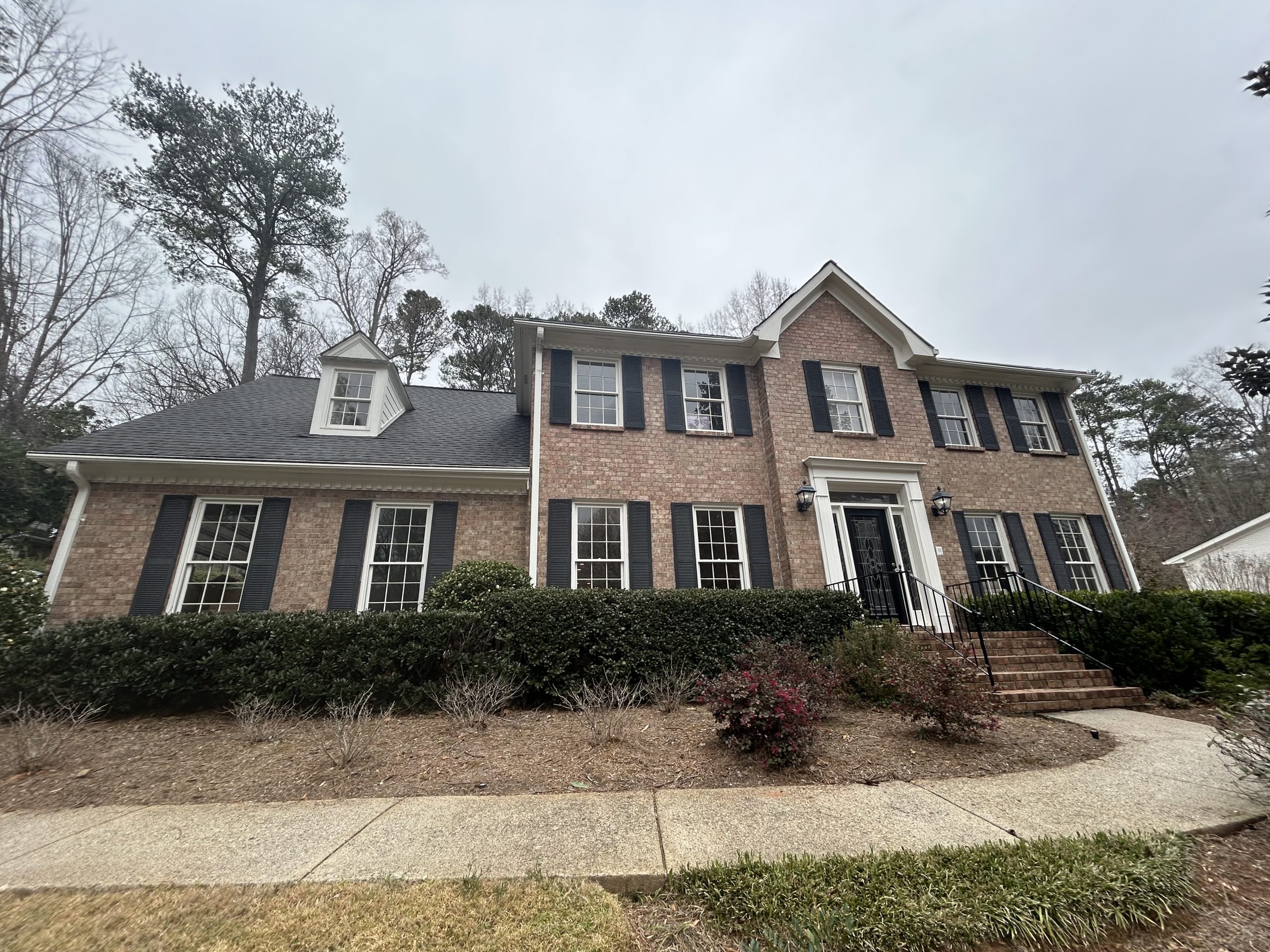 front of brick home before painting
