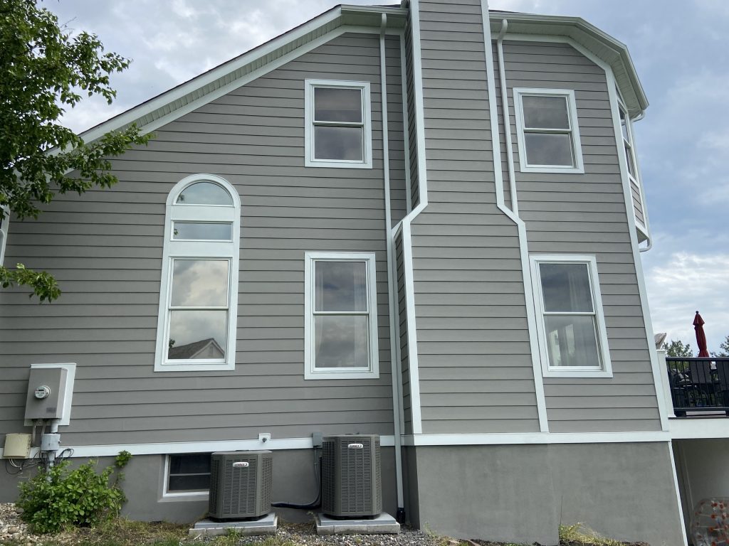 side of grey colored house after power washing and painting