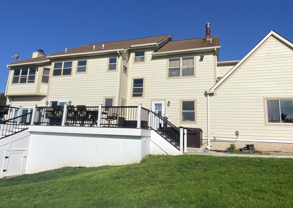 back of tan house before power washing and painting