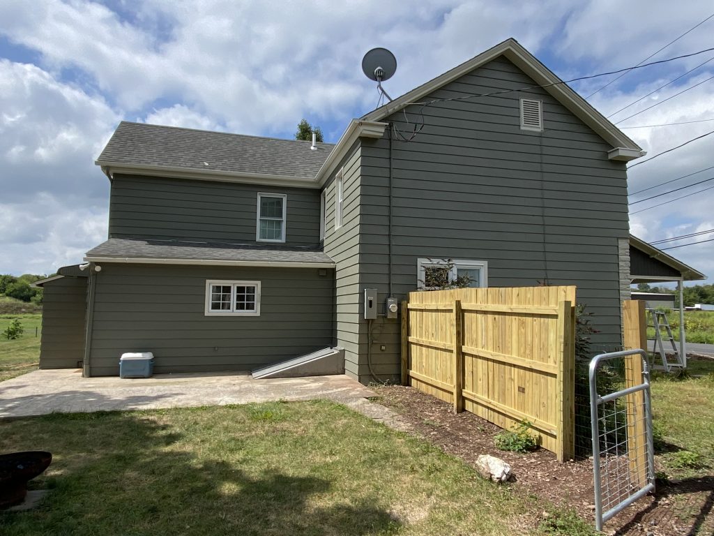 Dark greenish grey house after painting 