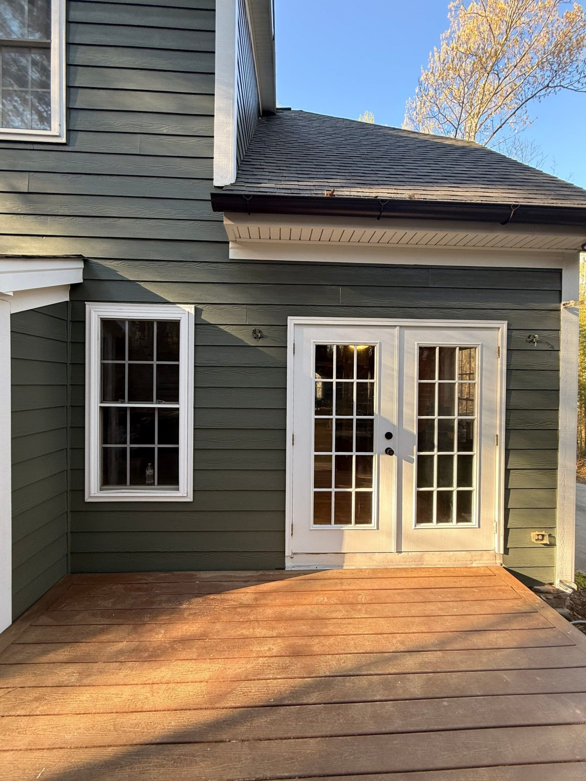home exterior entrance with blue siding and white doors