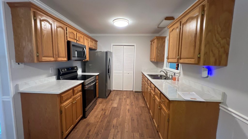 kitchen with light stained wood cabinets before painting