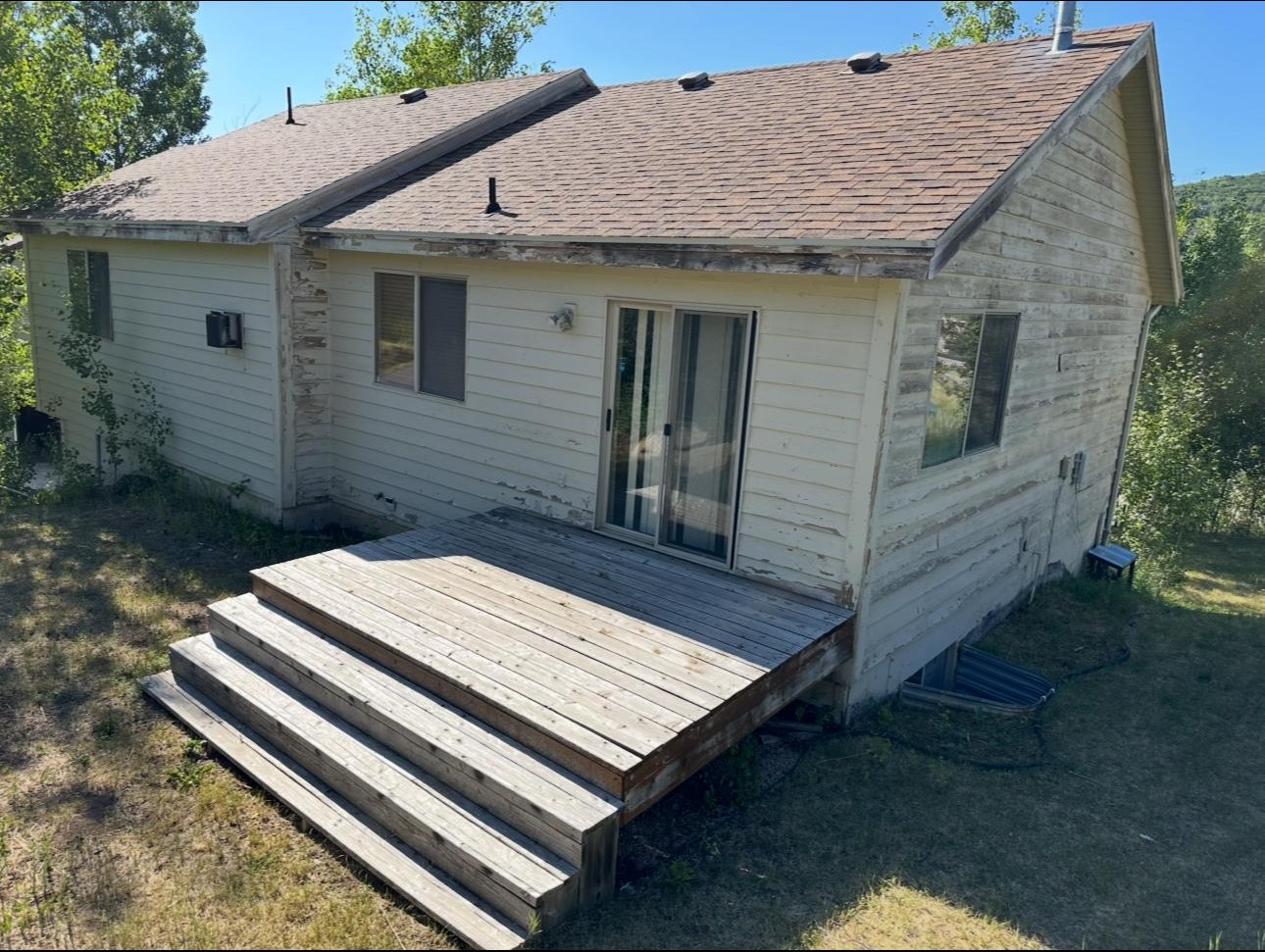 home exterior with damaged paint