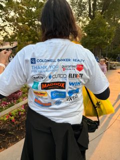 back of womans tshirt with event sponsors listed