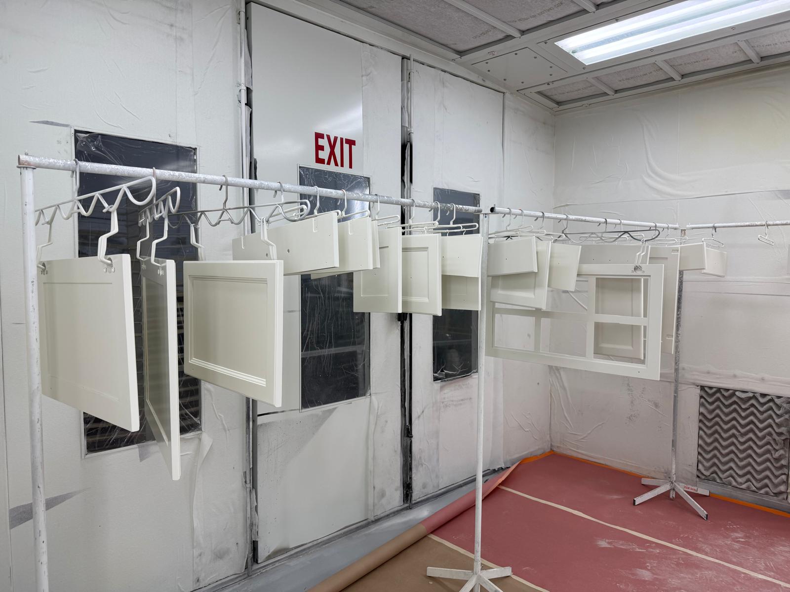 painted cabinet doors hanging on rack