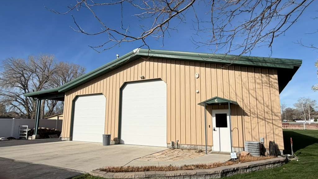 tan pole barn exterior with green roof