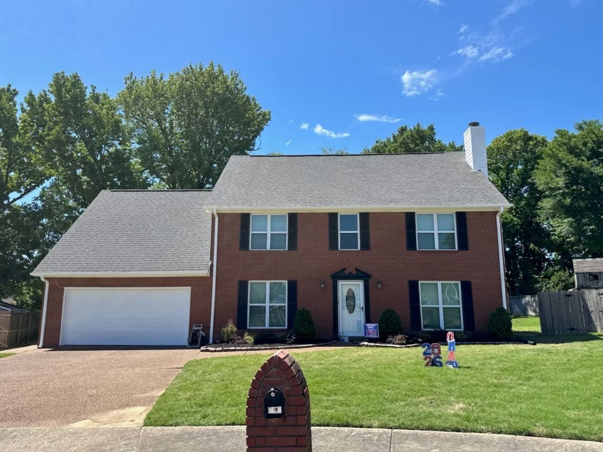 brick house exterior with black painted shutters