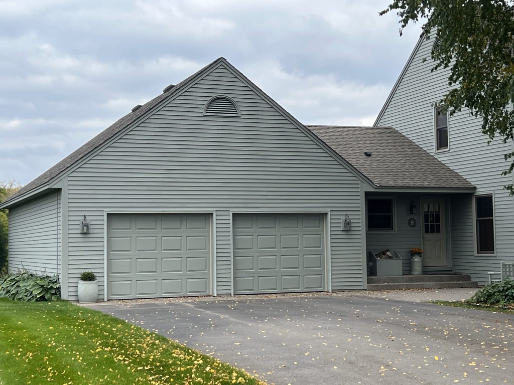 house and attached garage with painted siding