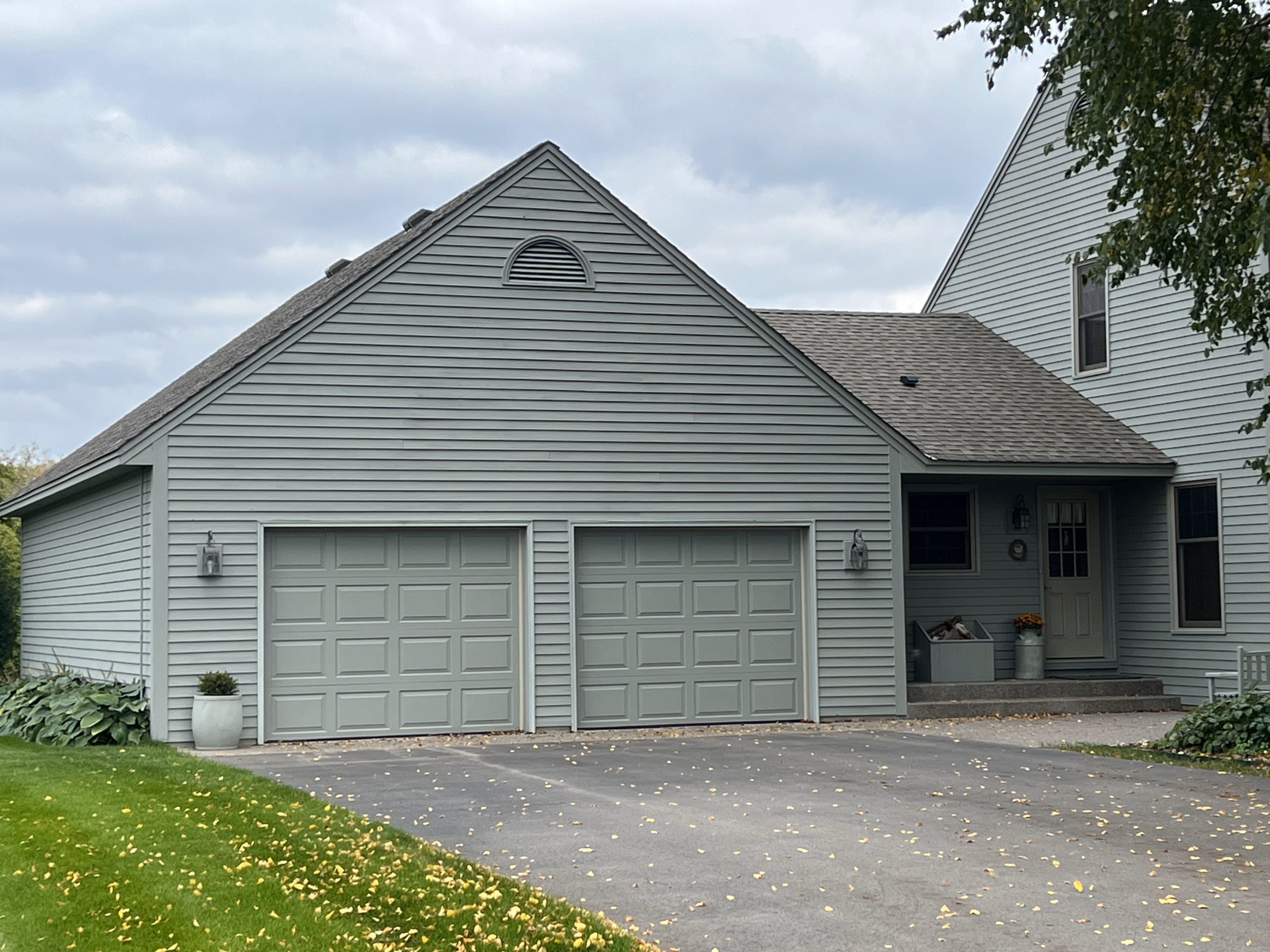 house and attached garage with painted siding