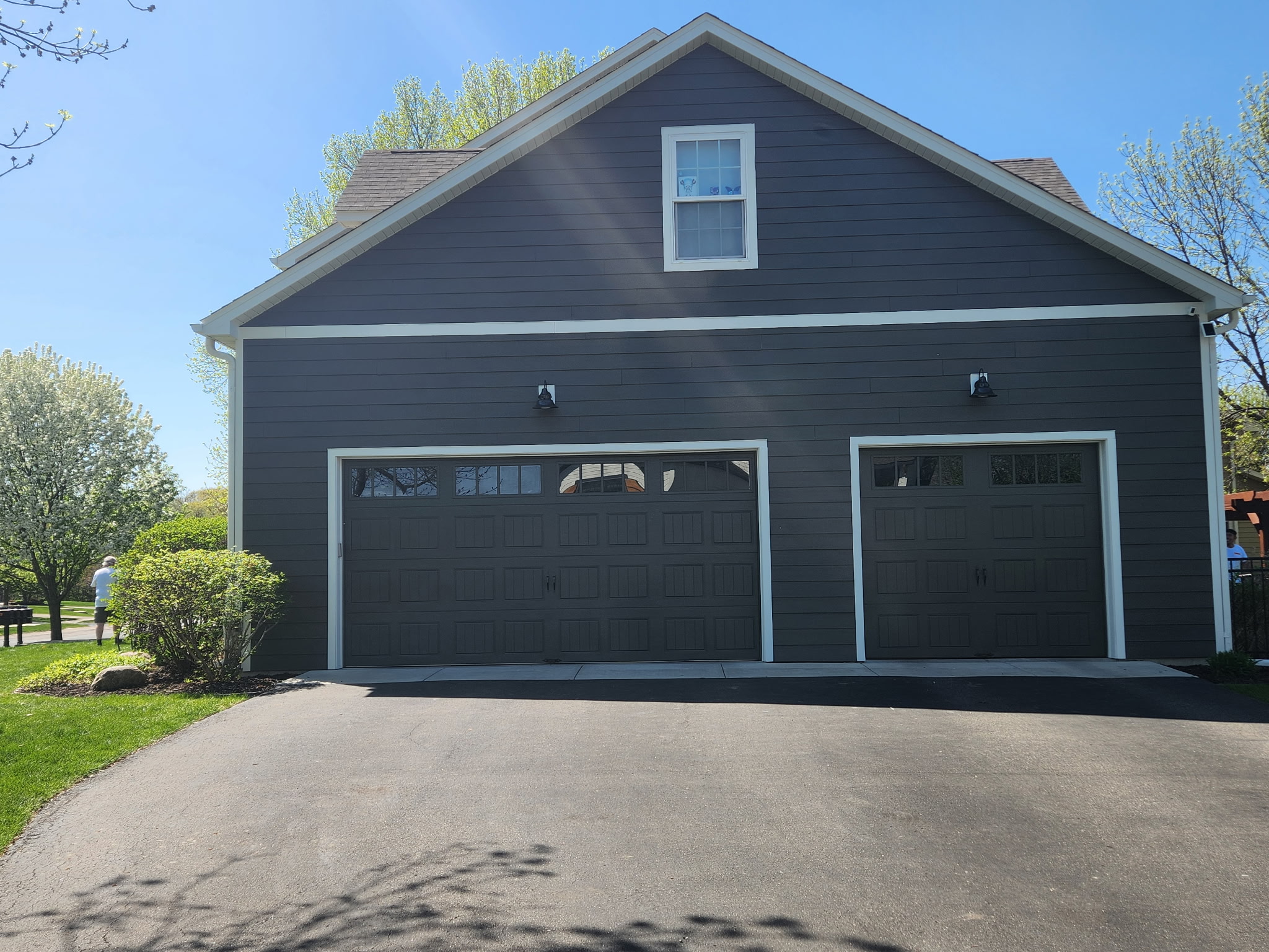 garage side of house with gray siding and driveway
