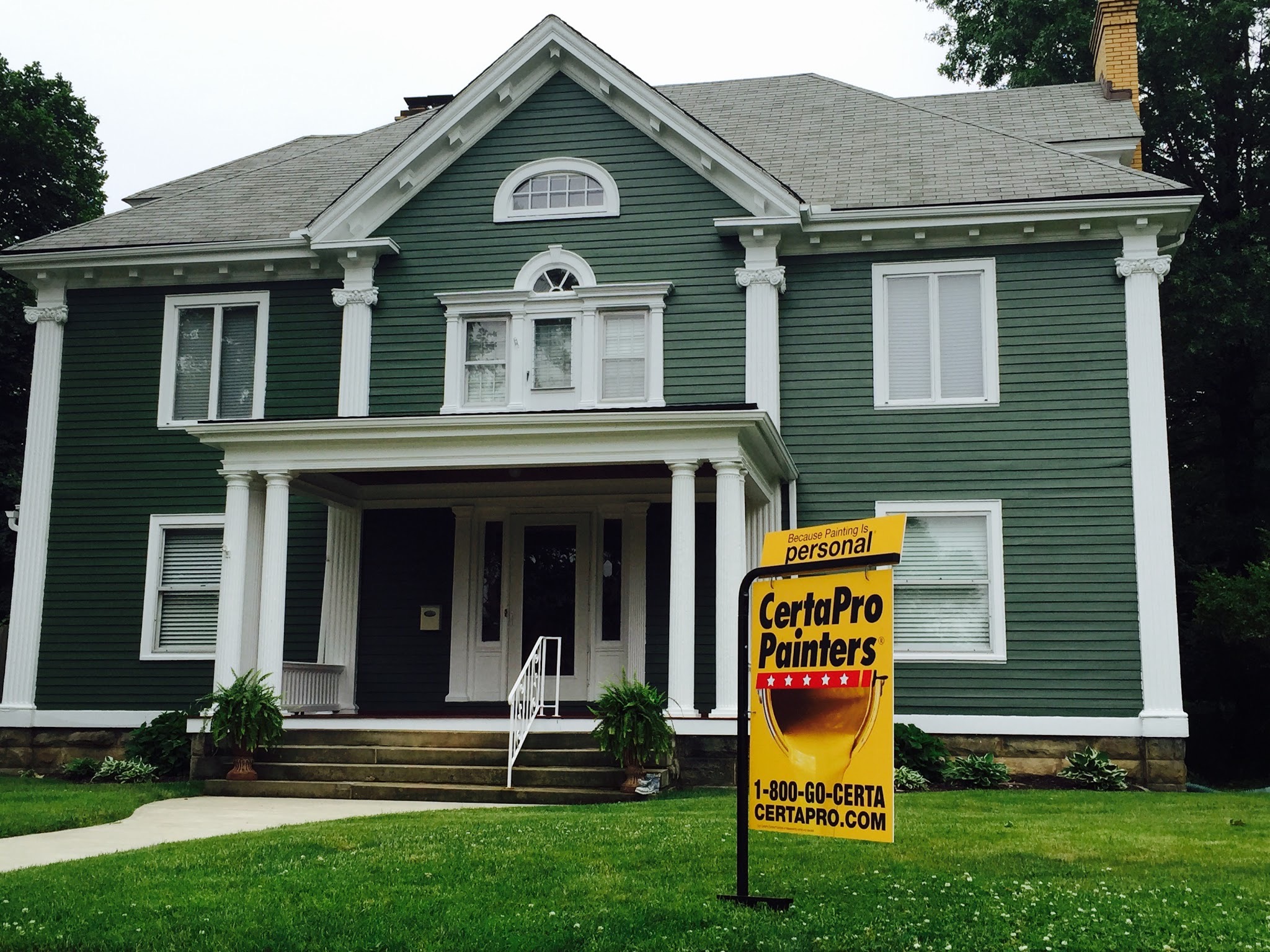 Green house with CertaPro sign in front