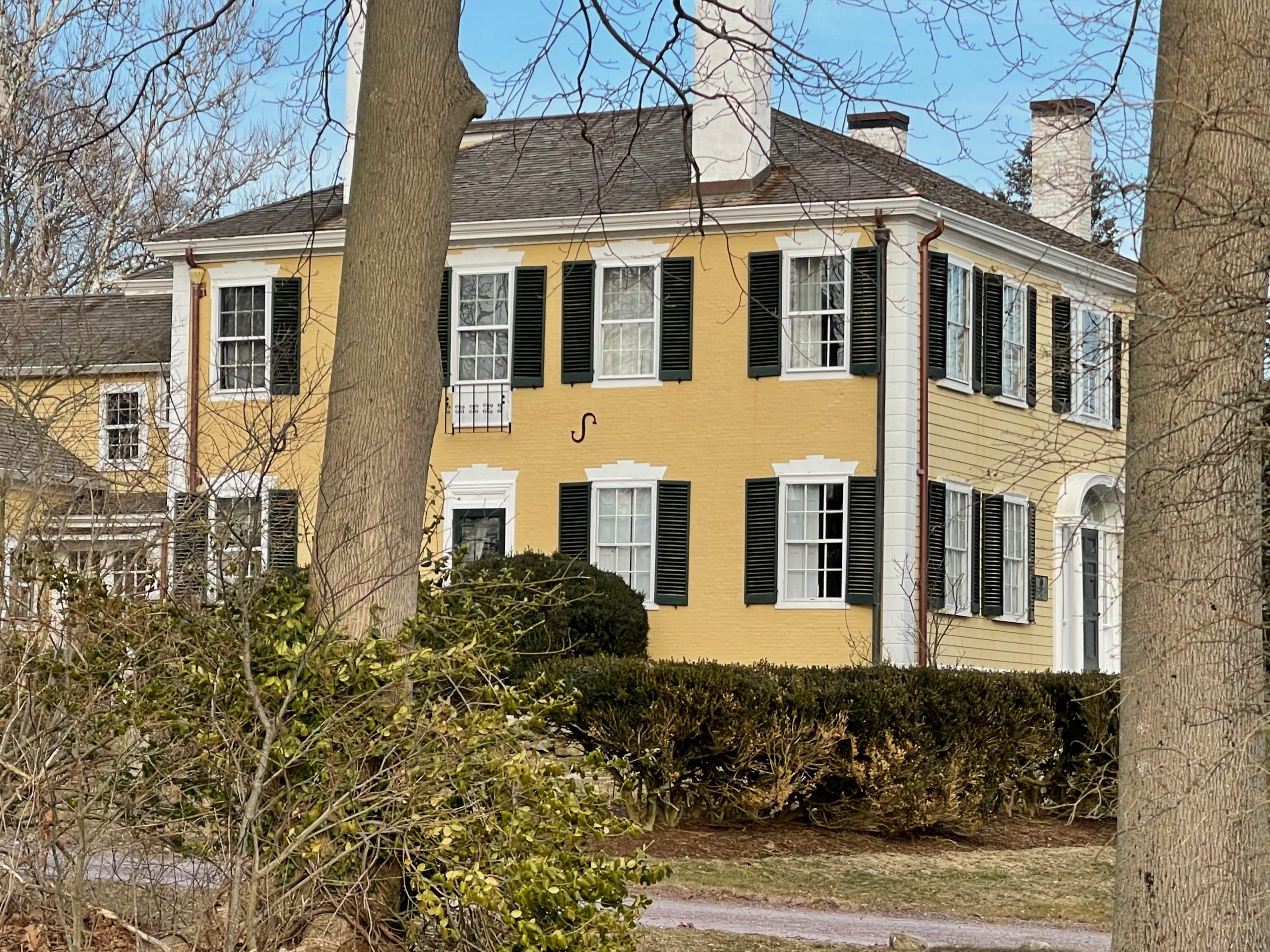 Yellow house black shutters