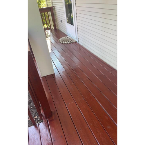 Mahogany deck on white clapboar house.