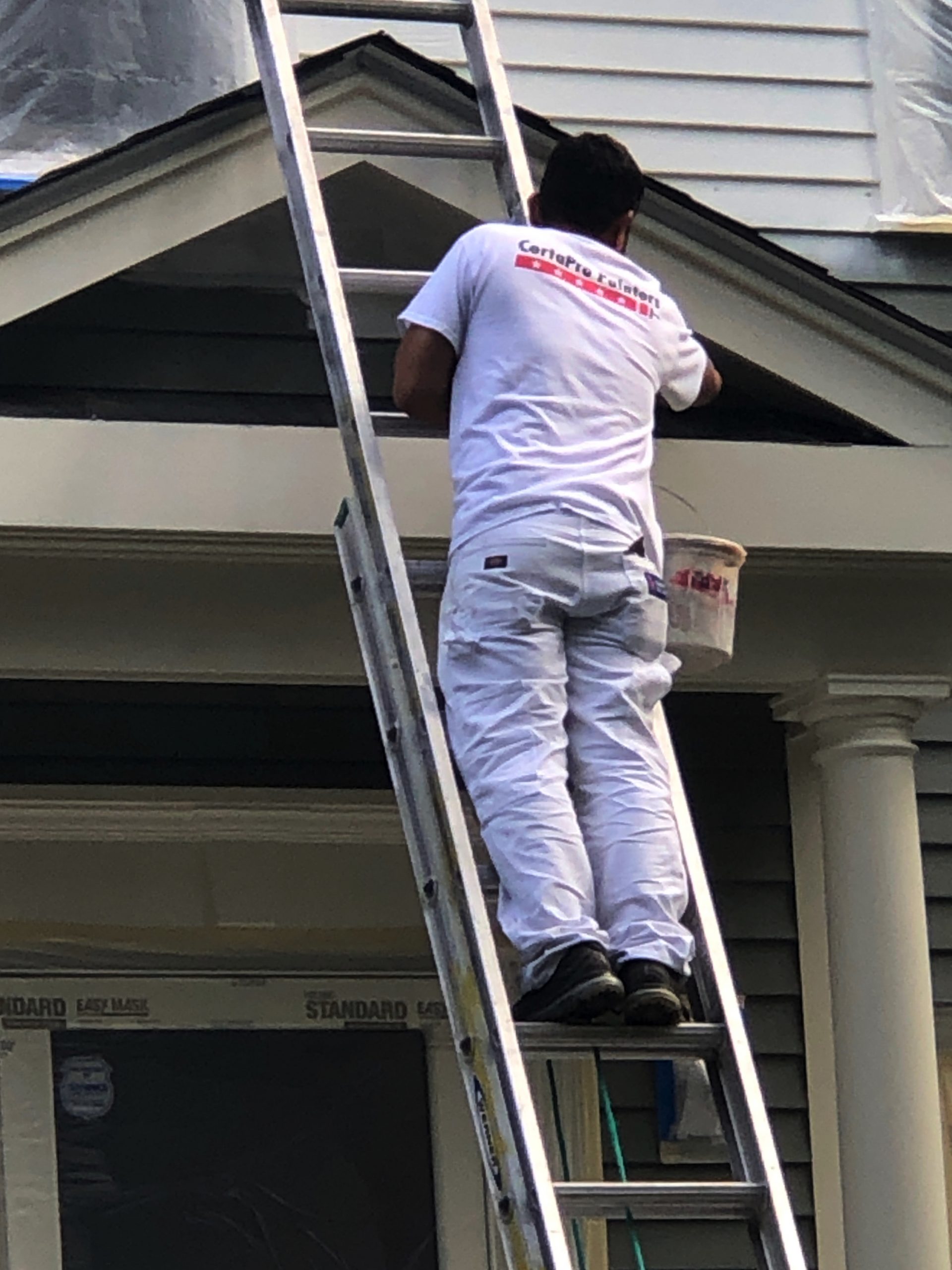 house painter working on house