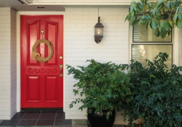Red door on white brick house