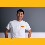 Painter in white CertaPro T shirt with gray wall