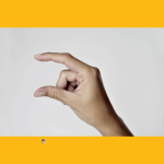 Hand with pointer finger on top and thumb on bottom