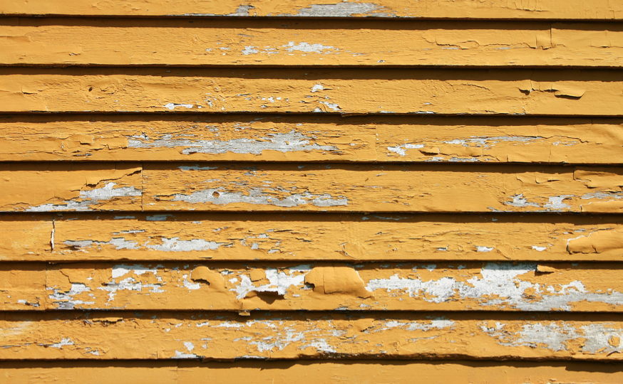 Peeling paint on yellow siding