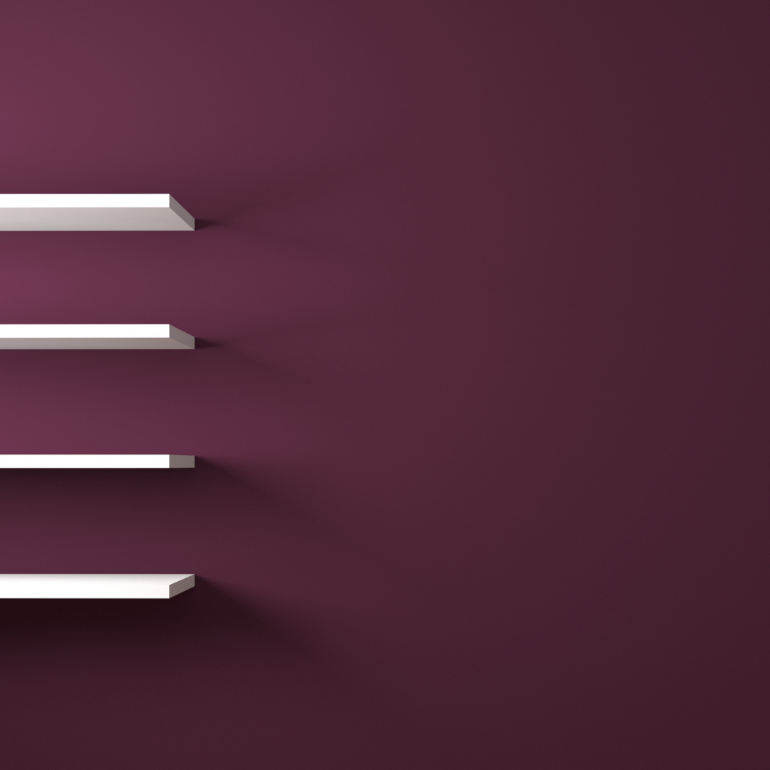 Dark purple walls with white shelves