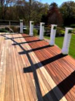 mahogany deck half stained and half raw wood at South Shore Country Club in Hingham, Massachusetts